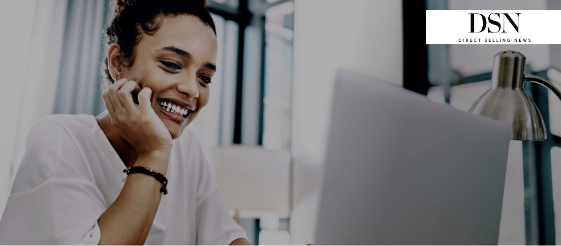 Image of a woman in front of a computer at her home office. 