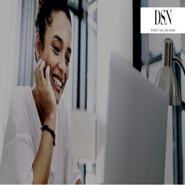 Image of a woman in front of a computer at her home office. 