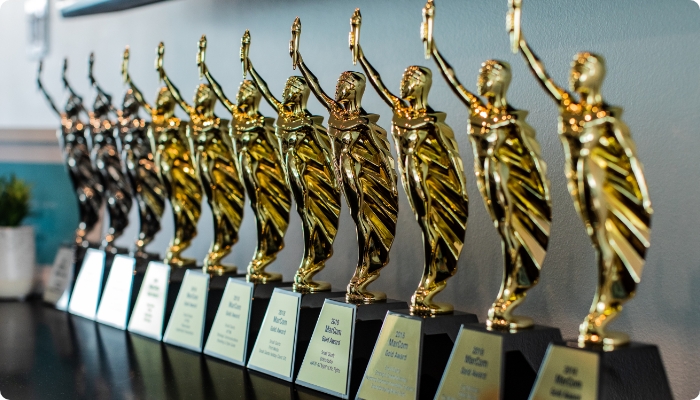Image of a row of eight MarCom Awards: three platinum awards and five gold awards.