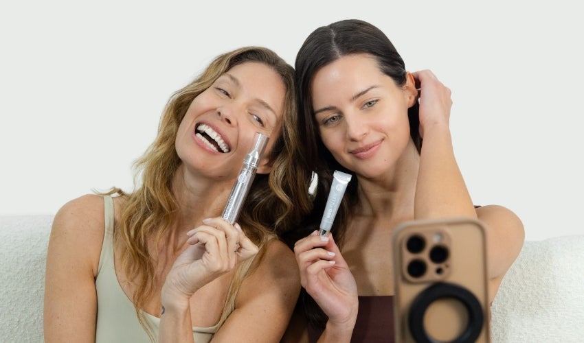 A pair of women posing and taking a selfie with the Neo-FILLER Face & Lip Contour Duo.