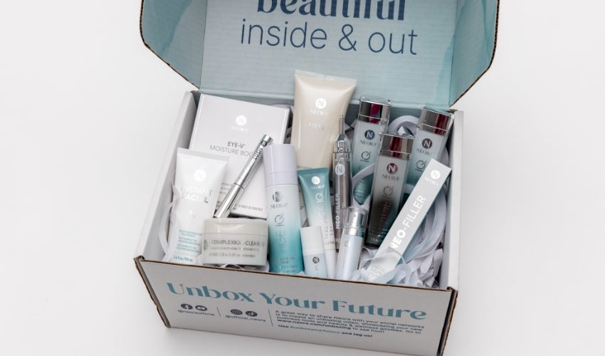 An opened Neora box filled with various Neora skincare products.