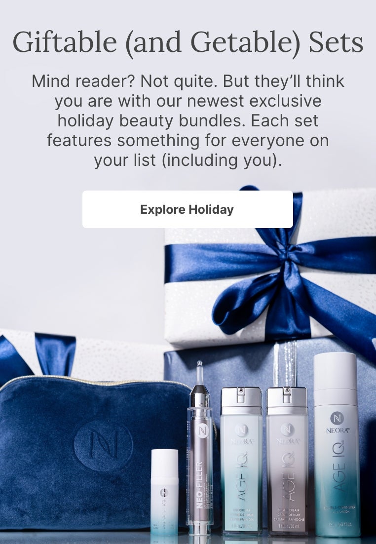 A bundle of Neora skincare products and a blue velvet Neora branded bag surrounded by festive gift boxes. Accompanying text mentions Neora’s newest exclusive holiday beauty bundles that are perfect for gifting to others or yourself.