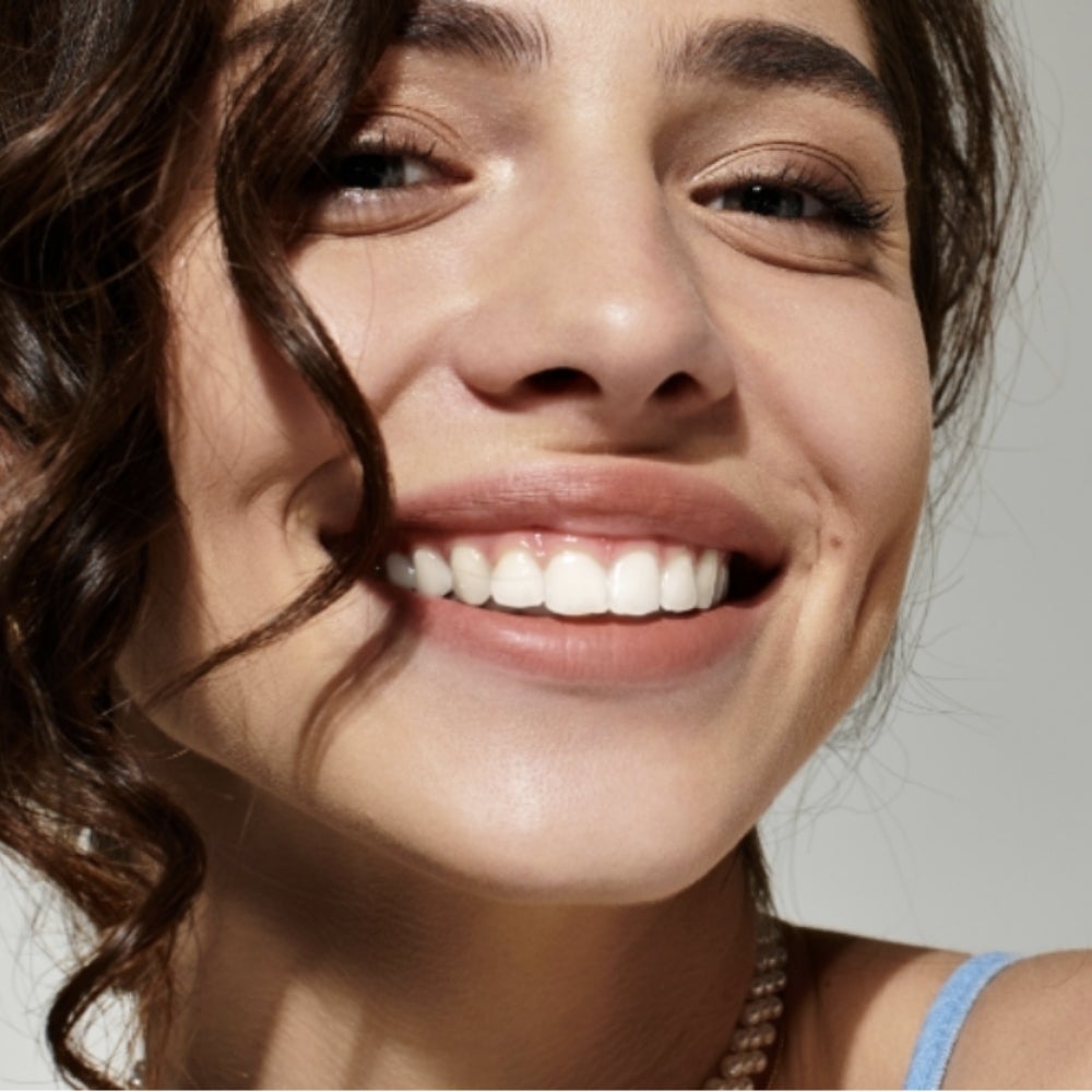 A headshot of a smiling woman.