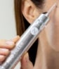 A woman holds up a Neo-Filler tube to her face.