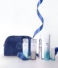 A bundle of Neora Skincare products and a blue Neora branded velvet bag.