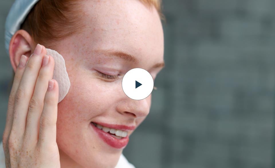 Thumbnail of a woman using the Acne Pads on her cheek.