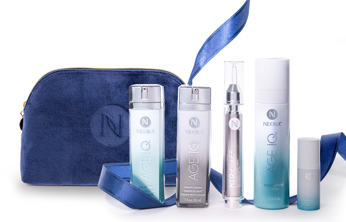 A bundle of Neora skincare products, which include Neo-FILLER, Age IQ Eye Serum, Age IQ Day & Night Creams, and Double-Cleansing Face Wash, surrounded by blue ribbon and a blue Neora branded velvet bag.