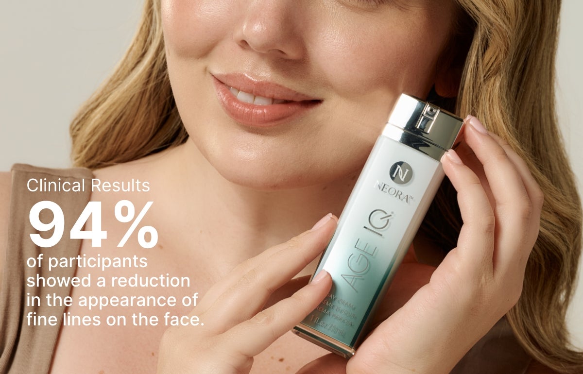 94% of clinical trial participants showed a reduction in the appearance of fine lines on the face. Featured is a woman holding an Age IQ Day Cream bottle next to her face.