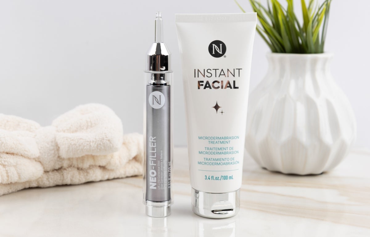 A Neo-FILLER tube and Instant Facial tube next to a spa band and plant.