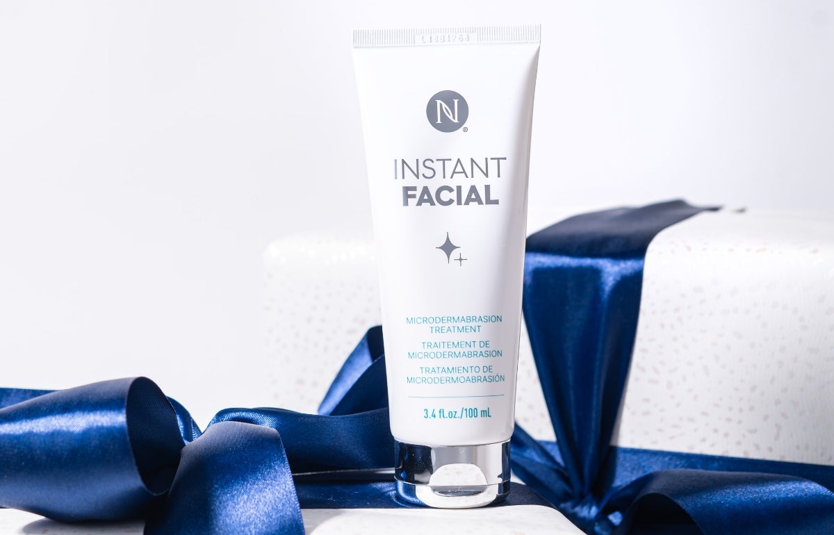 Neora’s Instant Facial tube surrounded by festive gift boxes.