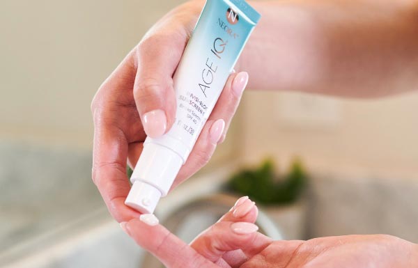 A woman applying the Invisi-Bloc SPF on her finger.