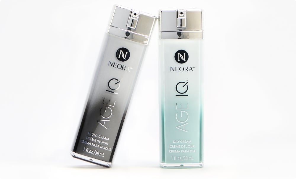 A bottle of Age IQ Night Cream leaning on a bottle of Age IQ Day Cream.