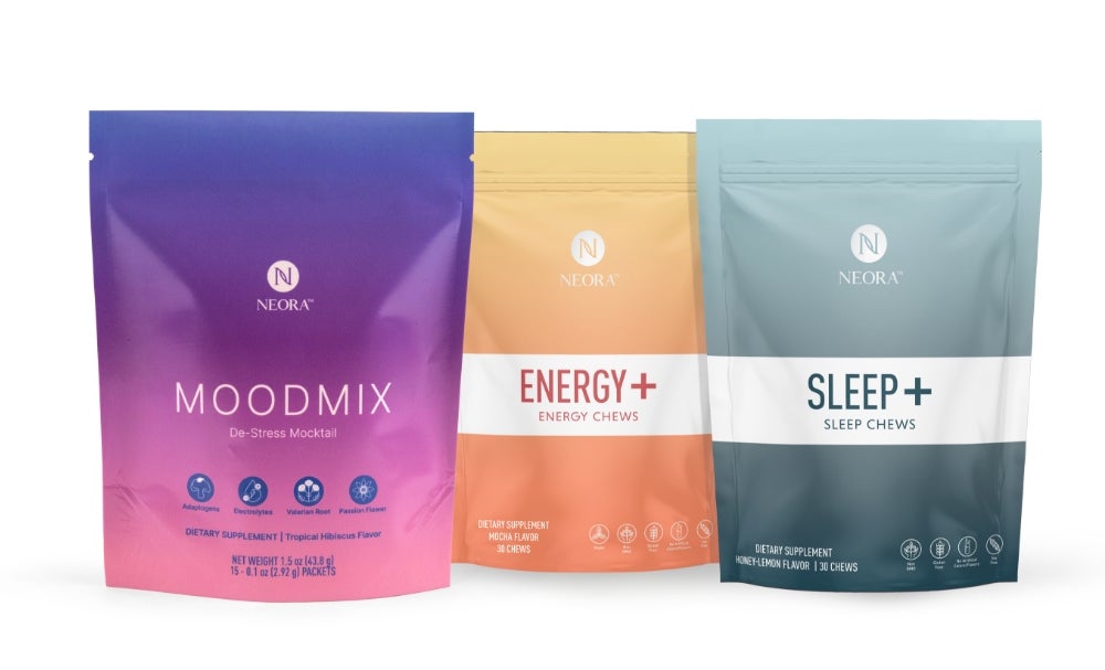 A bundle of Neora wellness products, which include a bag of MOODMIX, a bag of Energy+ Wellness Chews, and a bag of Sleep+ Wellness Chews.