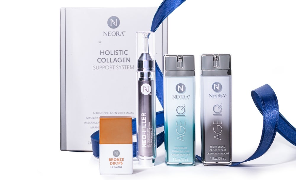 A bundle of Neora skincare products, which include Neo-FILLER, Age IQ Day & Night Creams, Bronze Drops, and a box of Holistic Collagen Sheet Masks, surrounded by blue ribbon.