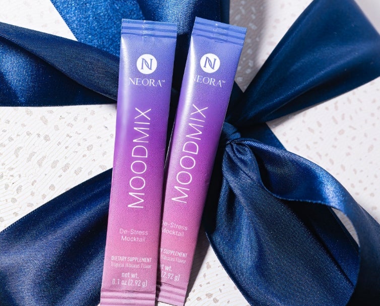 Packets of Neora’s MOODMIX on top of a gift box.