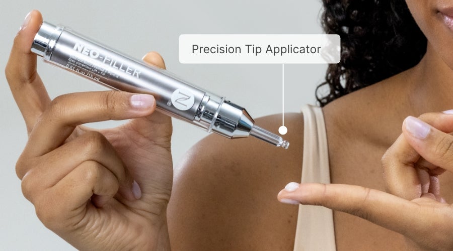 A woman applying a dab of Neo-FILLER on her fingertip.