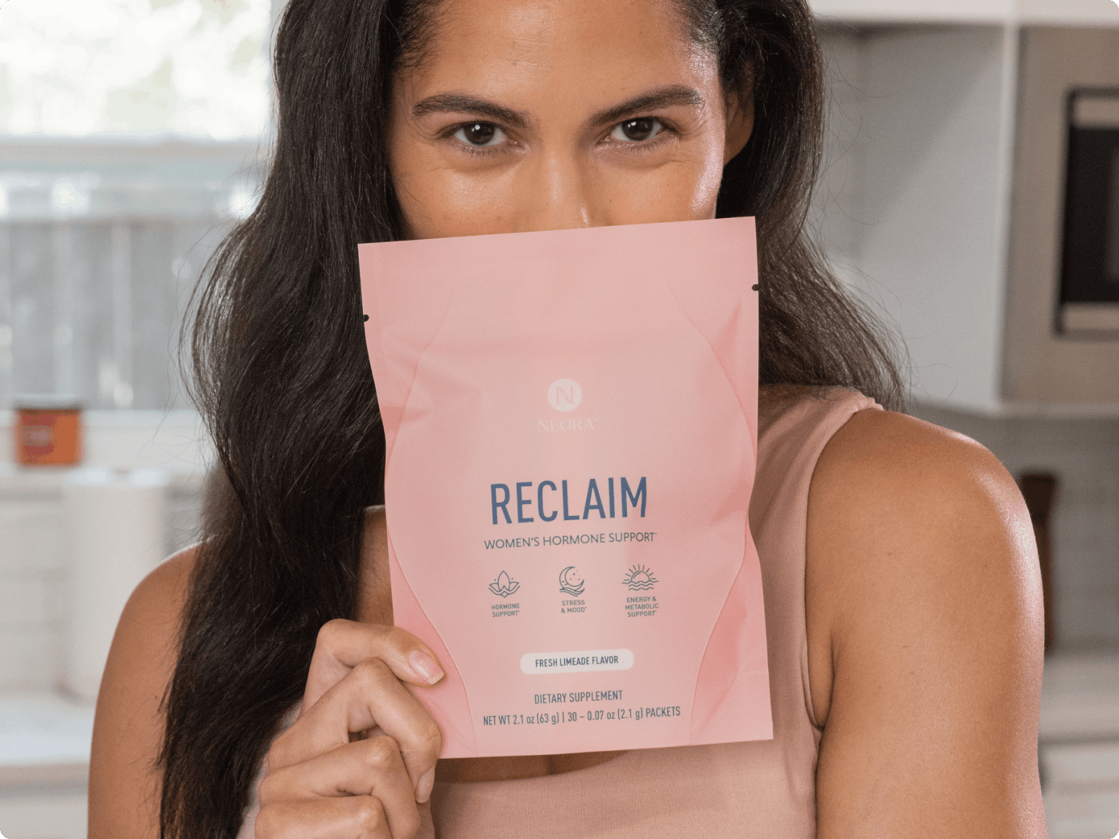 A woman covering her lower face with a bag of RECLAIM™.