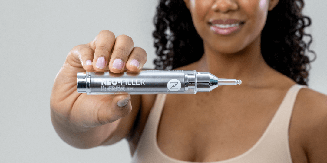 A woman holding up a tube of Neo-FILLER.