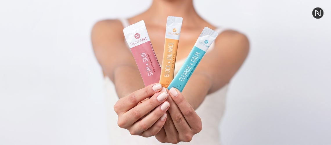 A woman holding NeoraFit sachets.