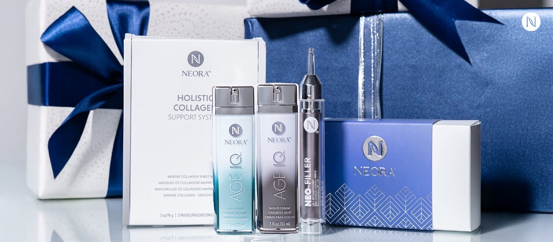 A bundle of Neora's Fill, Lift & Glow Set surrounded by festive gift boxes.
