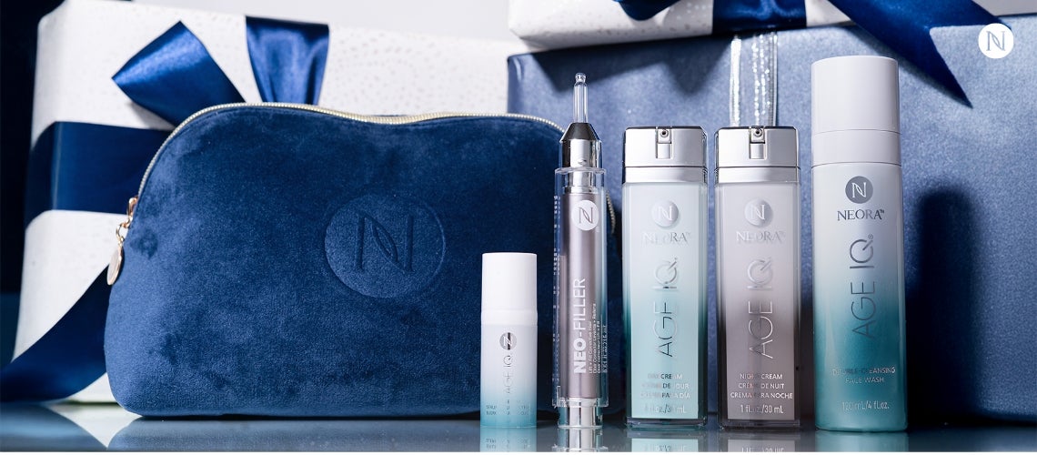 A bundle of Neora's Advanced Skincare Set with a blue Neora branded velvet bag.