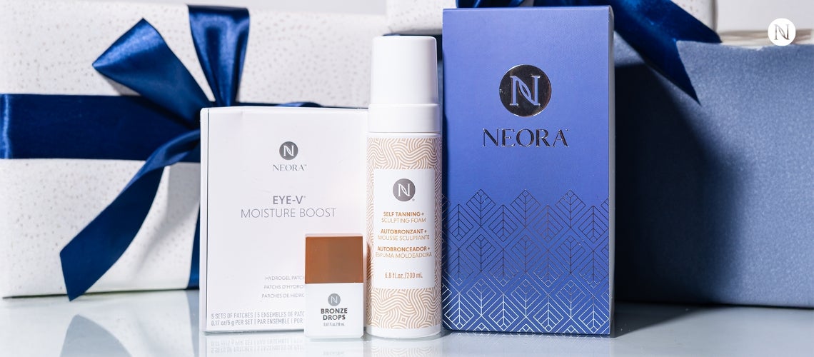 A bundle of Neora's NYE Glow Set surrounded by festive boxes.