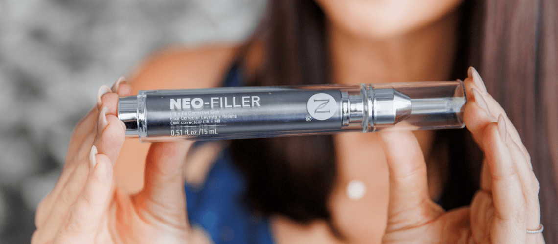 A woman holding up a Neo-FILLER tube.