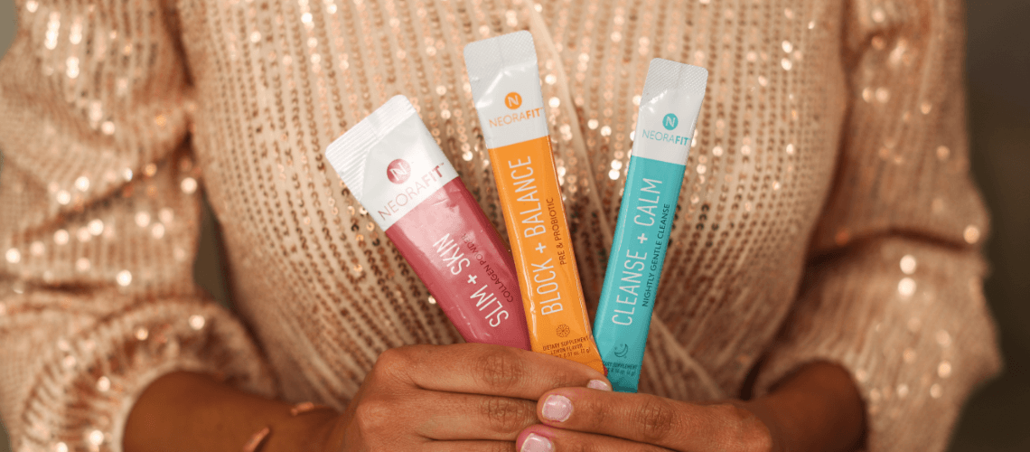 A person holding up sachets of NeoraFit.