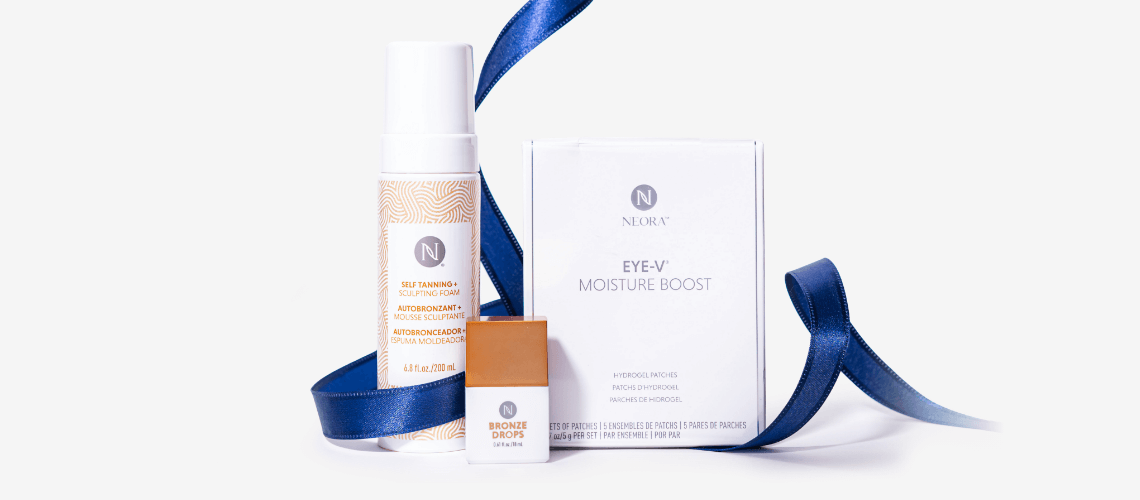 A bundle shot of the NYE Glow Set wrapped in blue ribbon.