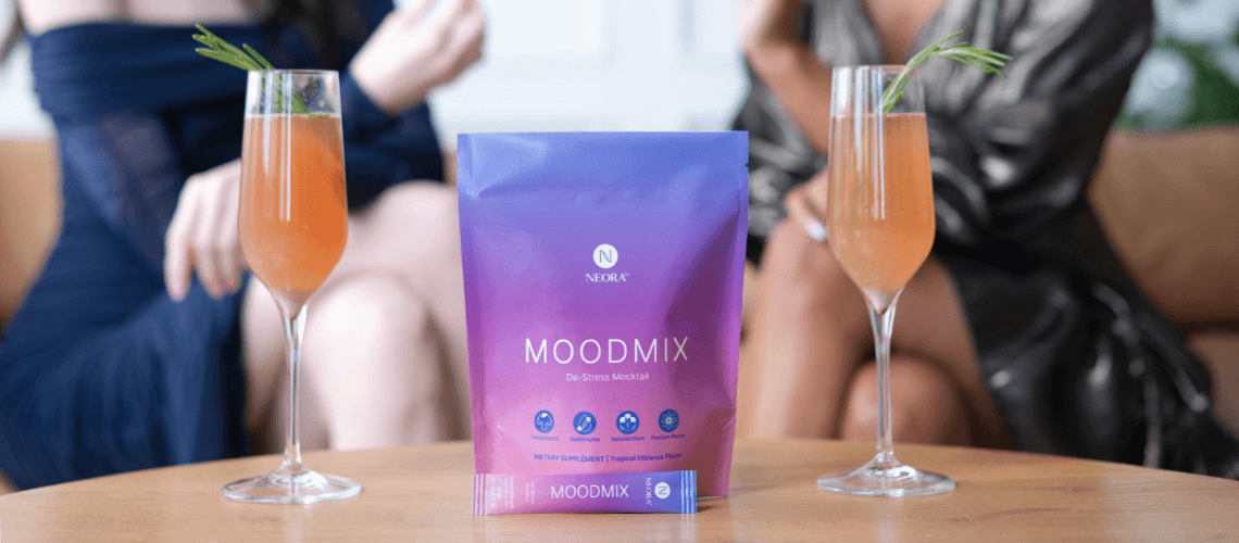 People sitting on a couch drinking behind a bag of MOODMIX.