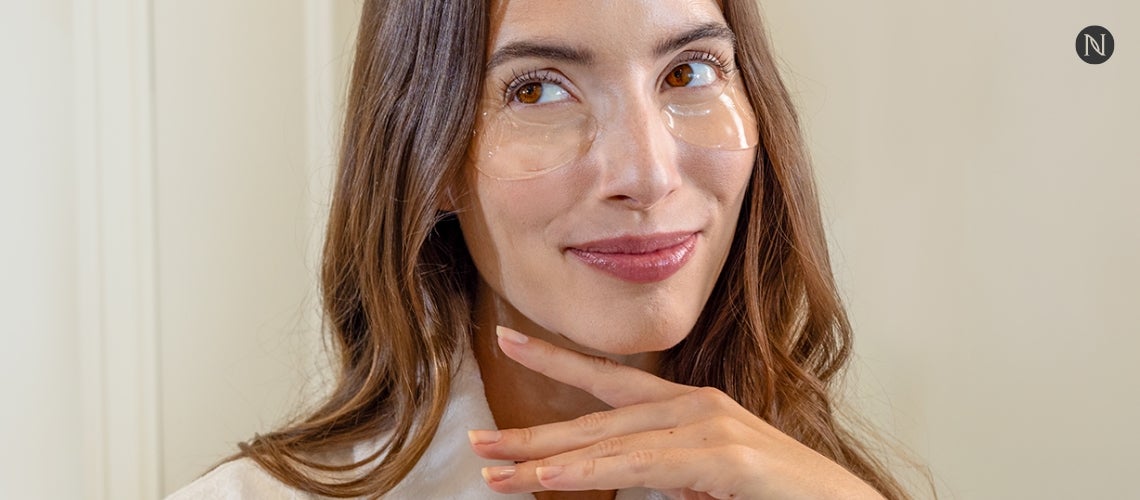 A content woman with Neora Eye Patches on her face.