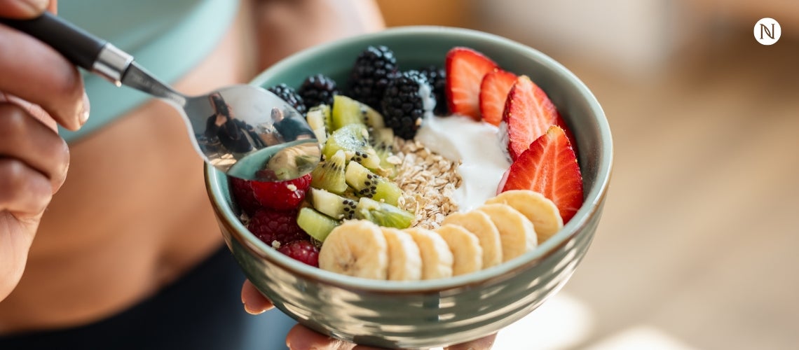 A lifestyle shot of a healthy fruit and yogurt bowl.