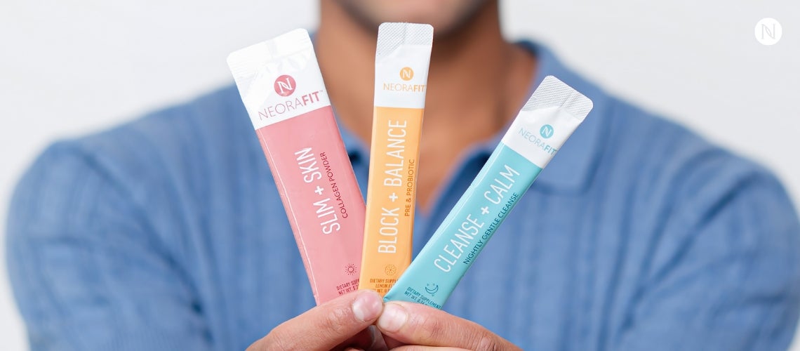 A person holding up three NeoraFit sachets.