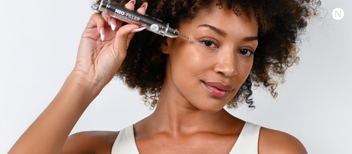 A woman holding Neo-FILLER to her temple.