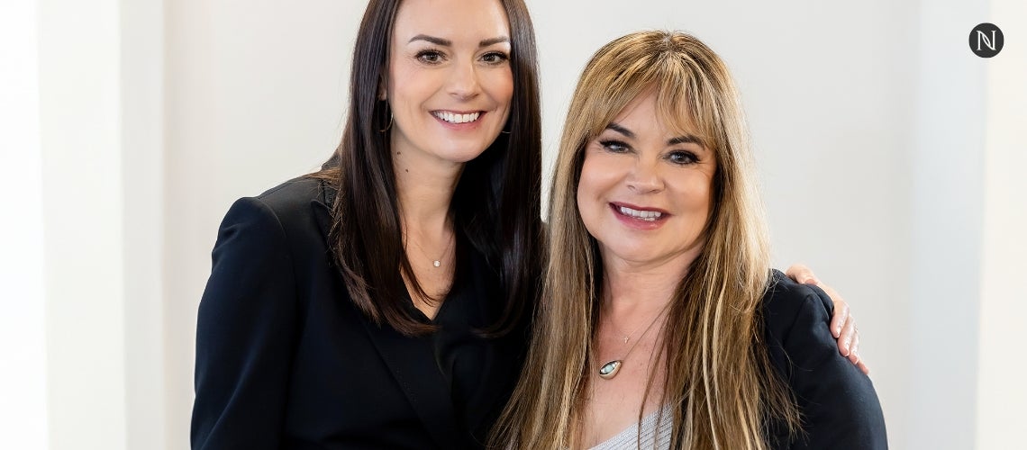 Amber Olson Rourke and Renee Olson posing together for a picture.