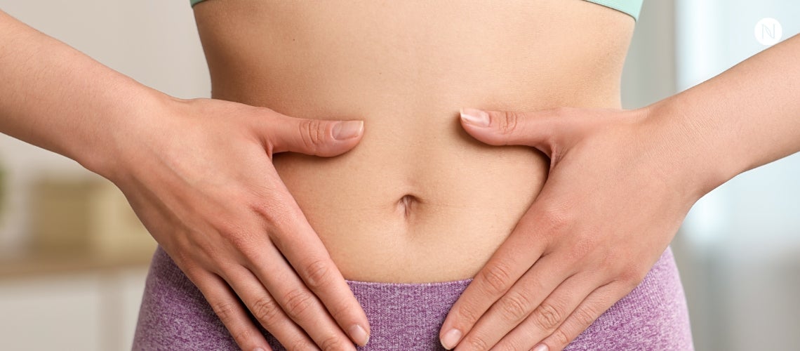 A woman holding her stomach.