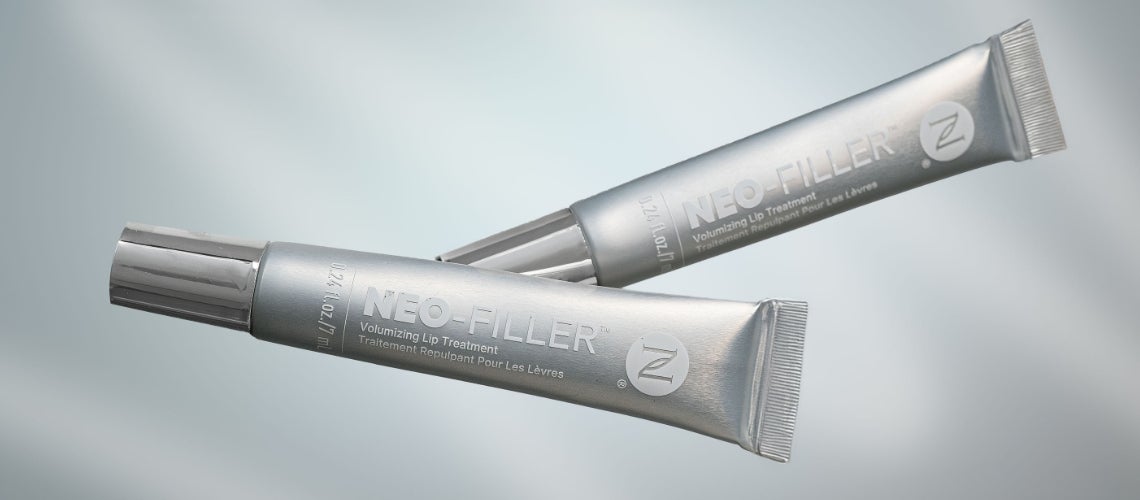 Two silver NEO-FILLER lip treatment tubes floating against a soft blue background, showcasing the product branding.