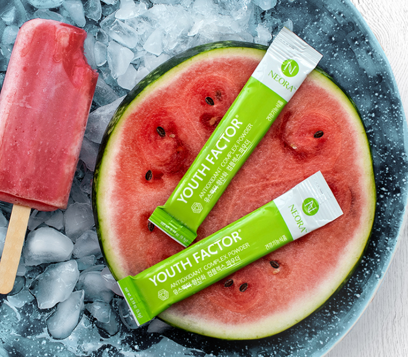 Neora Youth Factor® Superfood & Antioxidant (Powder) pictured with watermelon