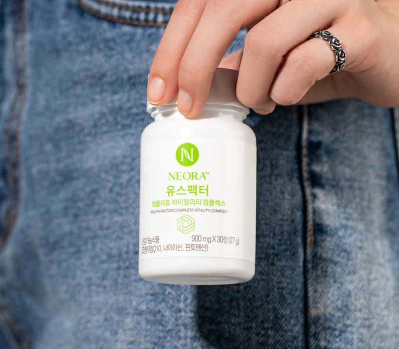 Neora Youth Factor® Vitality Complex bottle and pills shown pictured with berries
