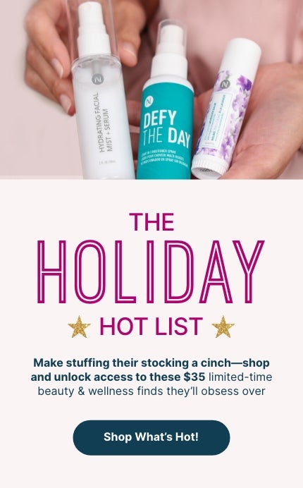 Woman holding Neora’s Holiday Hot List must-haves: Lip Plumping Serum, Hydrating Facial Mist and Zen + Calm Lavendar Balm. 