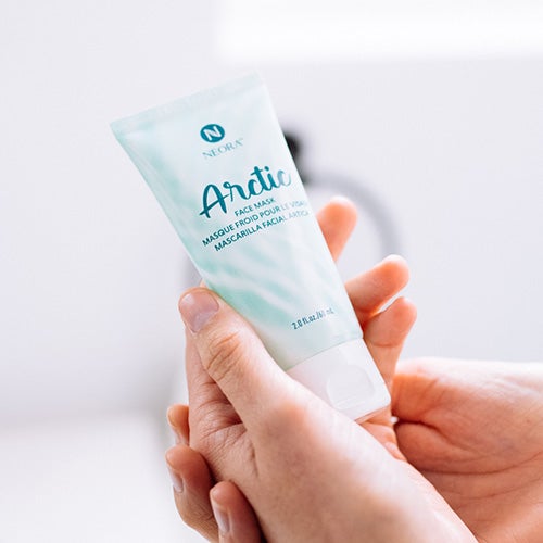 Woman holding Neora’s Holiday Hot List must-have, Arctic Face Mask.