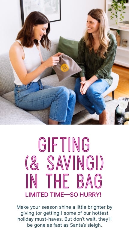 Gifting (& Saving!) in the bag with Neora's holiday must-haves. Woman smiling and holding Neora's All Eyes on You Holiday Set.