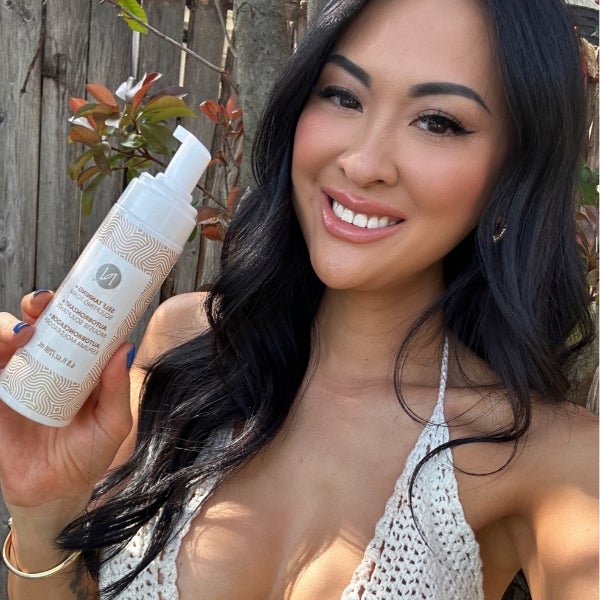 Photo collage showing a bikini-clad woman posing with the 3-in-1 Self Tanning and Sculpting Foam, sunkissed legs on a beach with the product bottle, and the product on a beautiful, wave-lapped beach.